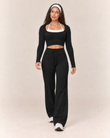By Shybani Flow Square-Neck Long-Sleeve Top in Black — front stepping pose