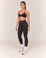 By Shybani Halter Sports Bra in Black — front three-quarter