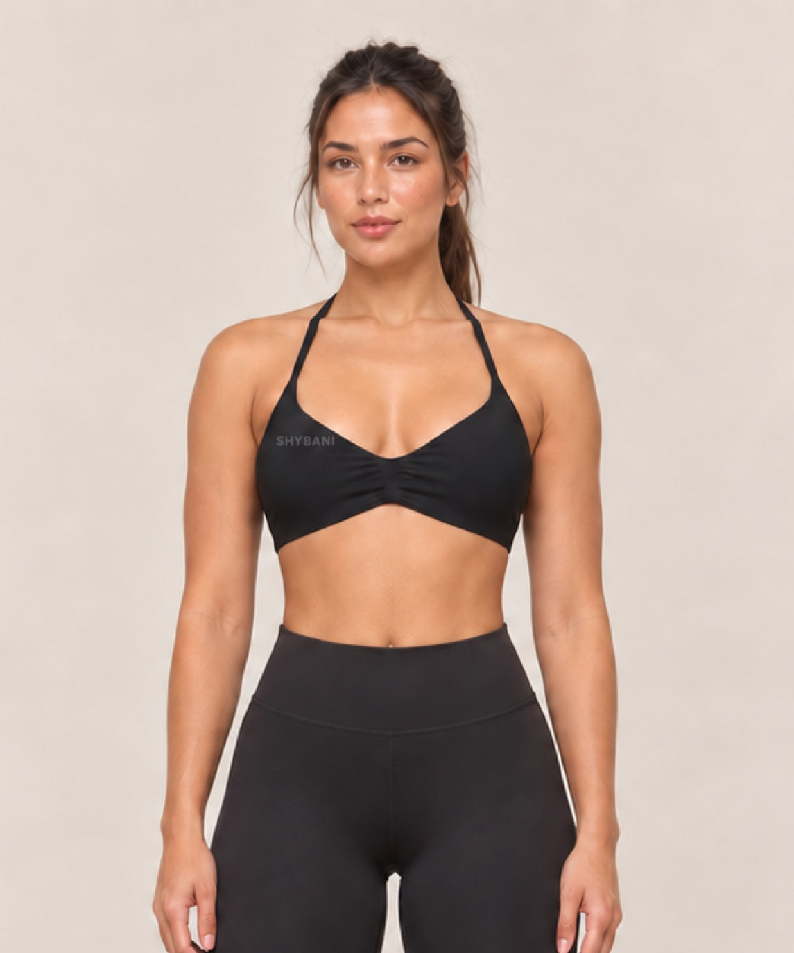 By Shybani Halter Sports Bra in Black — front