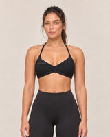 By Shybani Halter Sports Bra in Black — front