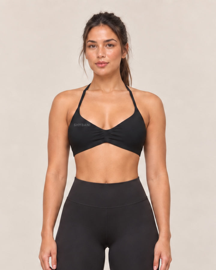 By Shybani Halter Sports Bra in Black — front
