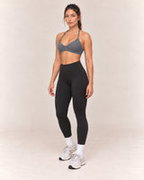 By Shybani Halter Sports Bra in Dark Grey — front three-quarter