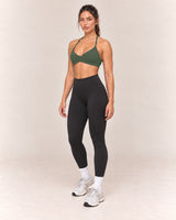 By Shybani Halter Sports Bra in Olive Green — front three-quarter