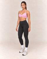 By Shybani Halter Sports Bra in Pink — front three-quarter