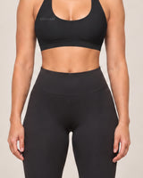 By Shybani Scoop-Neck Halter Bra in Black — hem and fabric detail